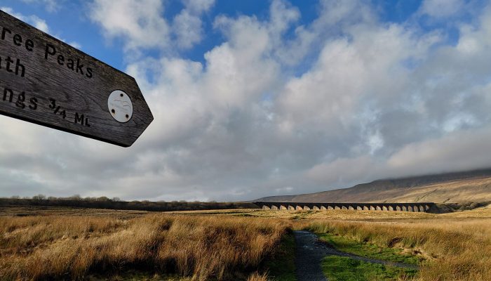 Ribblehead_Viaduct_autumn-winter_CHJ (1) A wooden signpost in front of the Ribblehead Viaduct